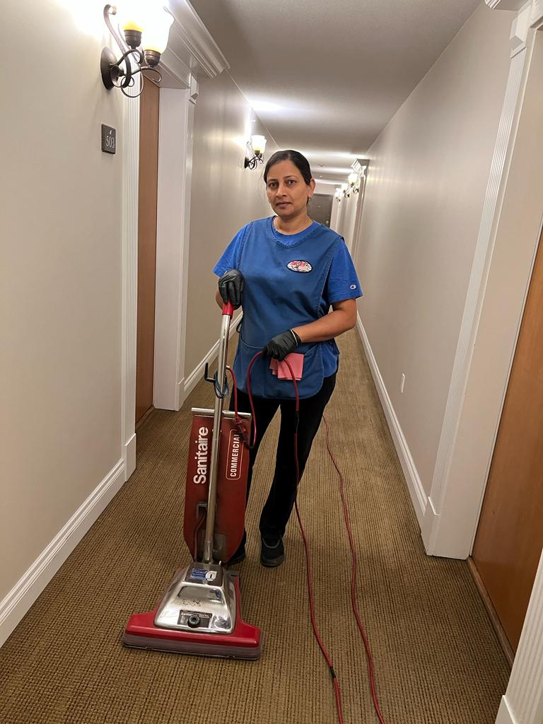 Female Worker Vacuuming